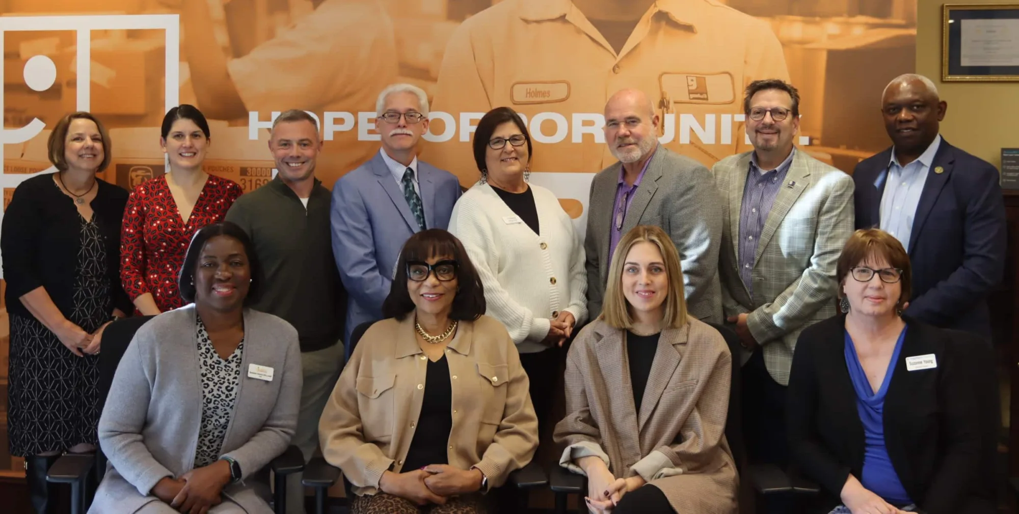 Group of 12 people smiling for the photo
