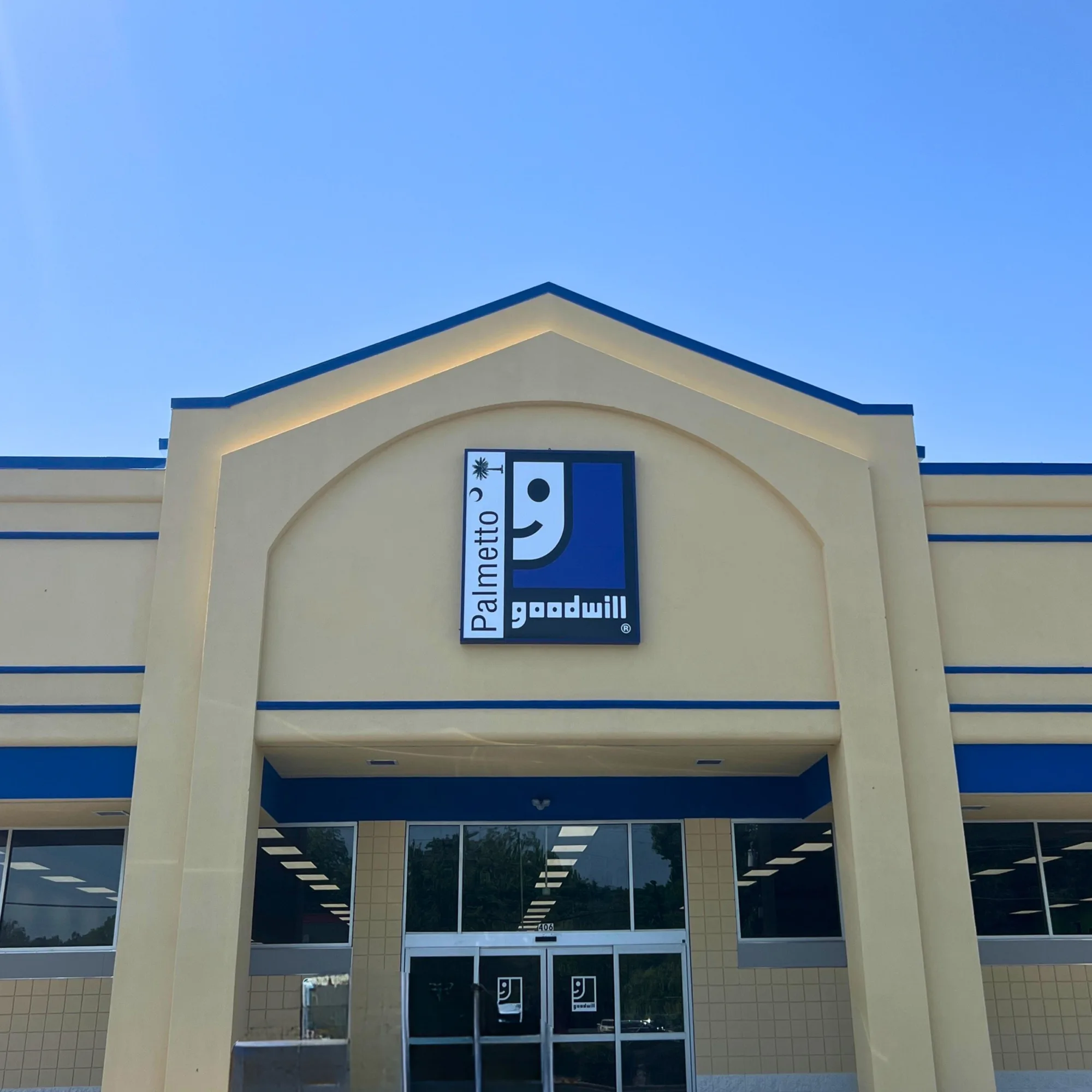 Exterior of the Palmetto Goodwill Darlington retail store under a clear blue sky