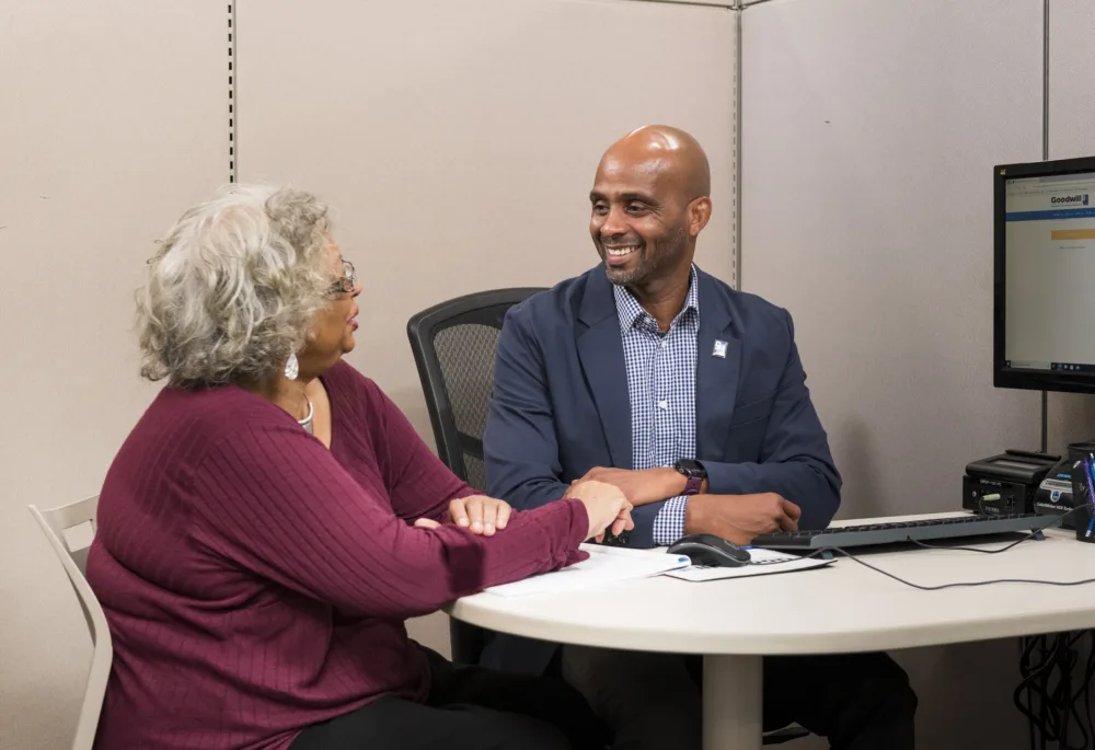 Mature woman receiving one-on-one career change coaching from a Palmetto Goodwill Success Coach, discussing free job training for seniors 55 plus South Carolina.