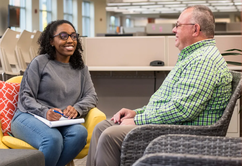 Palmetto Goodwill Success Coach meeting one-on-one with a job seeker, providing personalized mentorship and guidance at a Career Opportunity Center (COC).