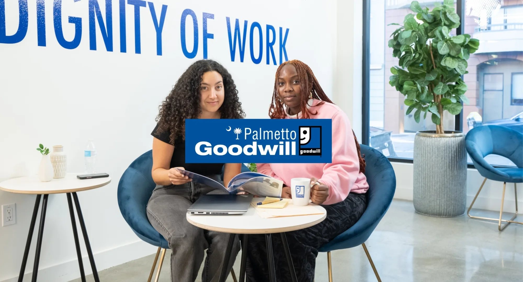 Palmetto Goodwill logo over two job seekers collaborating with a success coach on career documents, symbolizing free job help and voucher assistance.