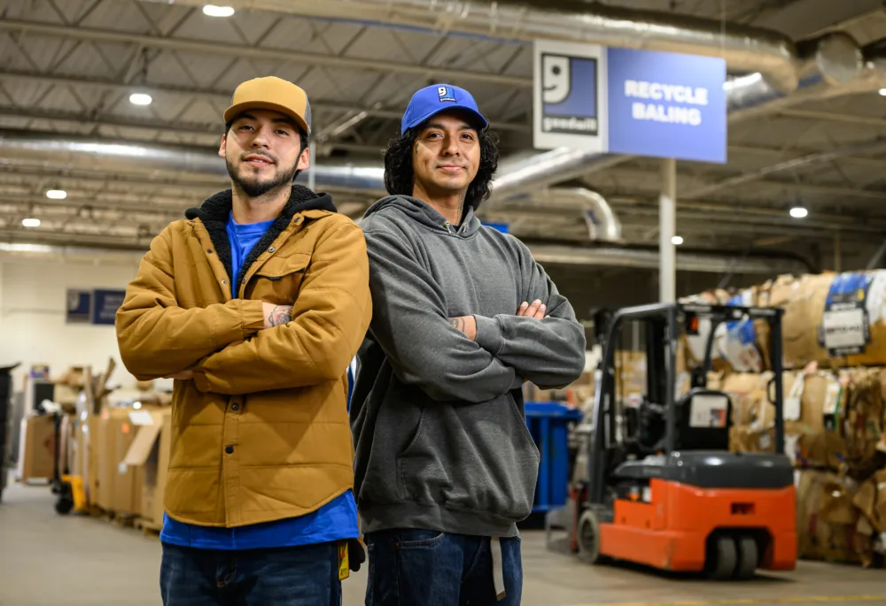 Palmetto Goodwill operations team in a warehouse setting, demonstrating the landfill diversion and recycling efforts of the best thrift store SC residents support.