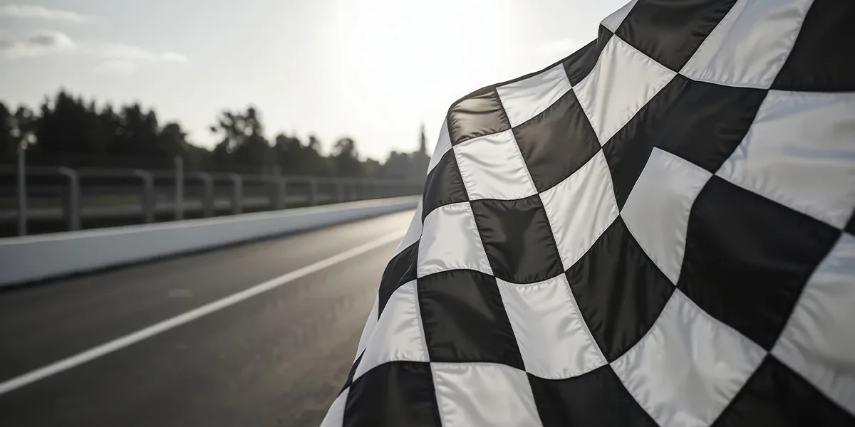 A checkered flag waving at a racecourse.